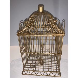 Gold tone wore birdhouse that opens from the top